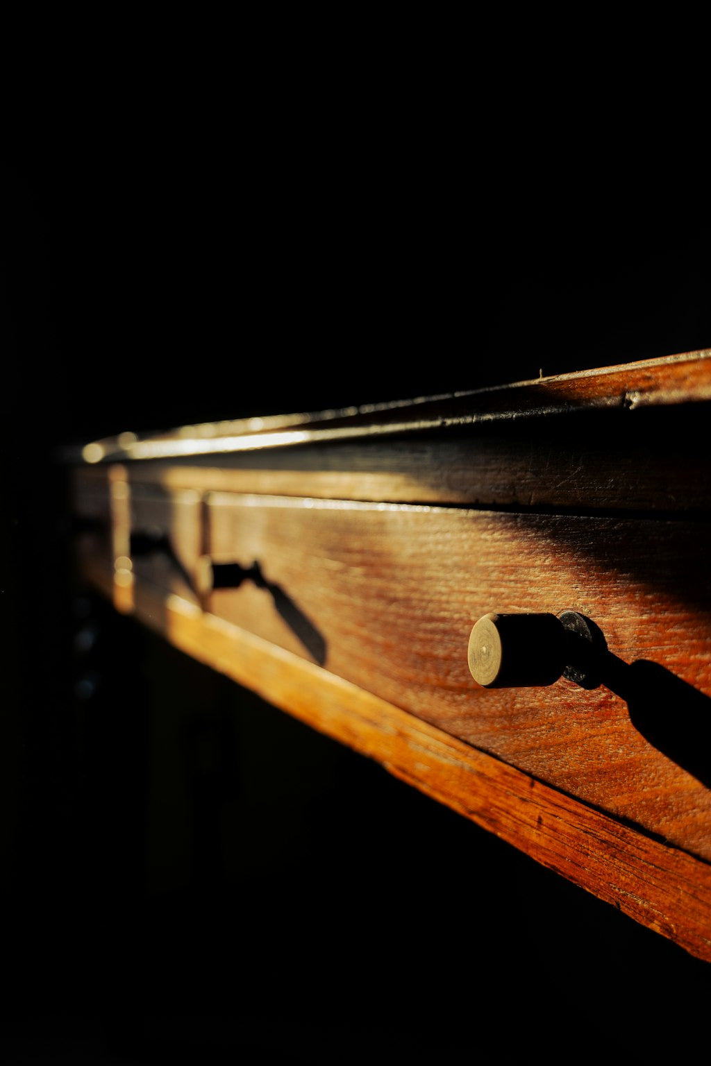Close-up of a wooden drawer with a dark background